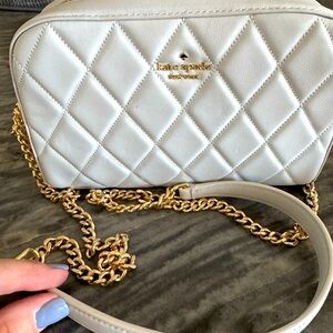 Grey Kate Spade small purse with gold hardware.